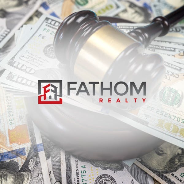 Fathom Realty logo and a judge's gavel on top of a pile of hundred-dollar bills