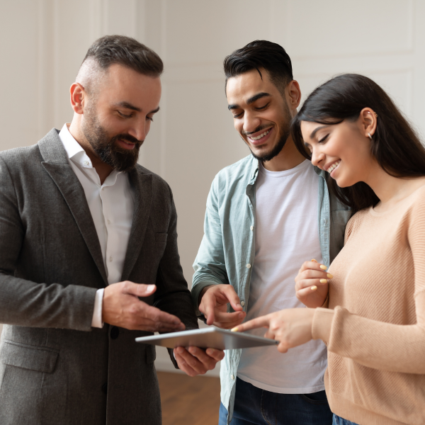 A couple looks at homes with a real estate agent.