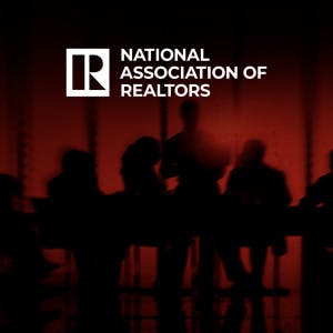 The National Association of Realtors logo and a darkened conference room