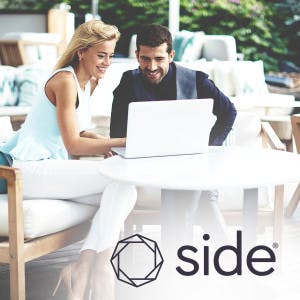 Side logo overlayed on image of man and woman staring at a laptop 