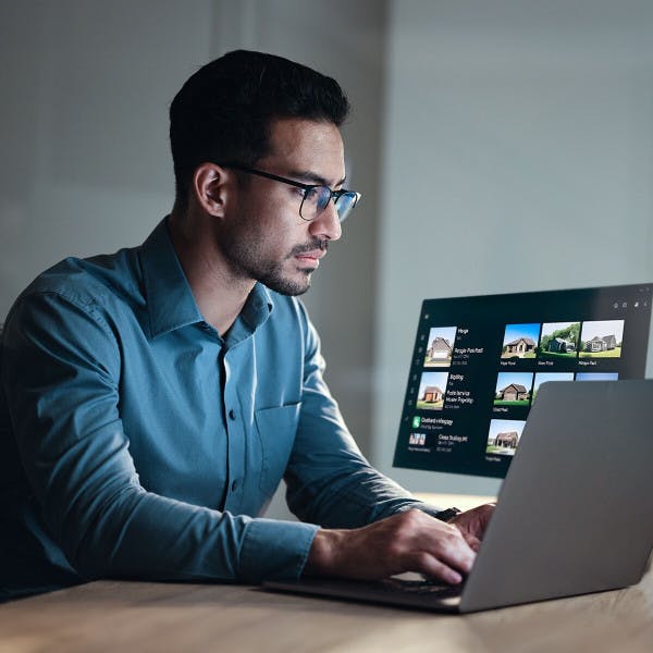 A businessman looks at property listings on his laptop