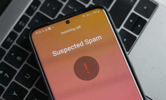 A cellphone receiving a call marked "suspected spam"
