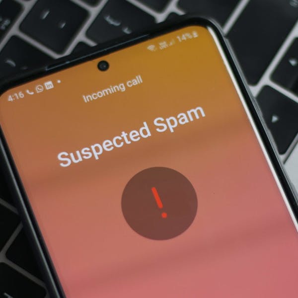 A cellphone receiving a call marked "suspected spam"