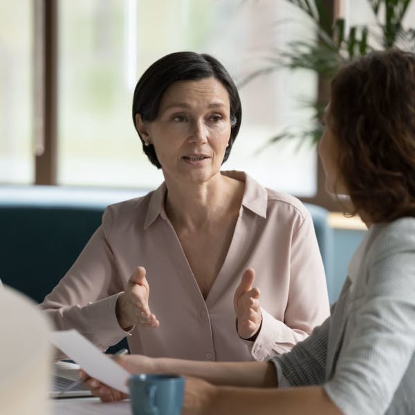 Two businesswomen having a serious discussion in an office