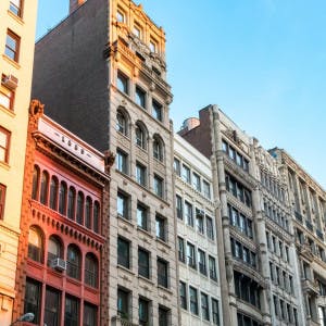 Row of tall historic buildings in the afternoon sunlight along Broadway in Manhattan, New York City