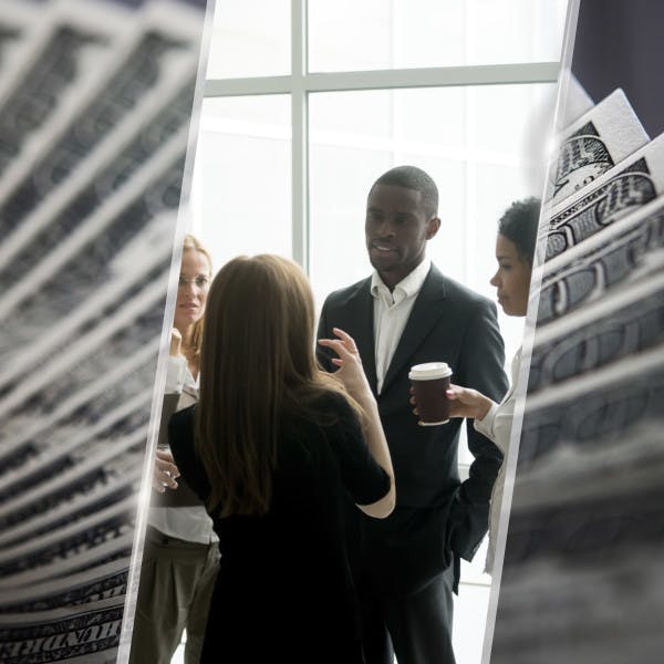 A group of businesspeople and a stack of hundred dollar bills