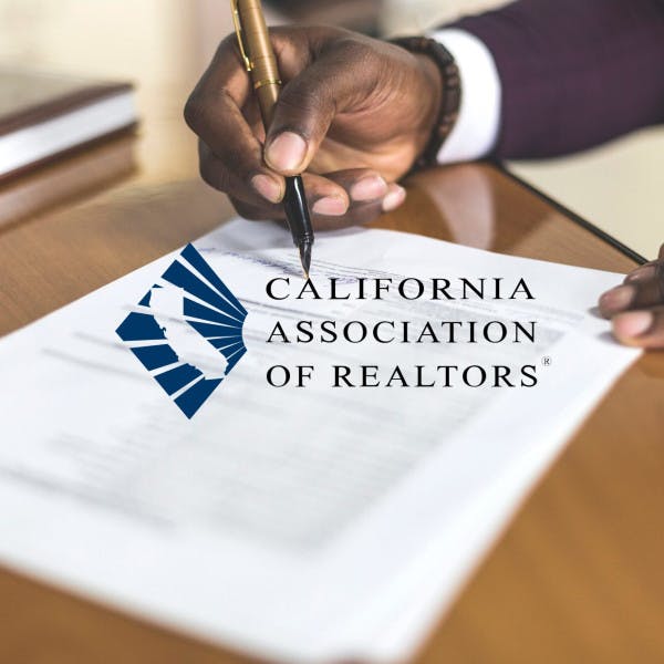 The California Association of Realtors logo and a Black man signing a legal document
