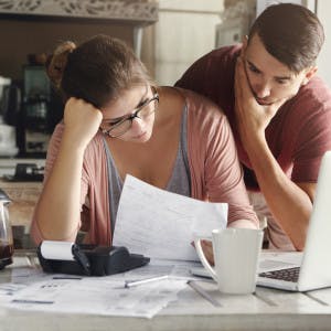 Couple stressed looking at papers