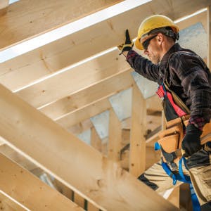 Man standing over new construction home